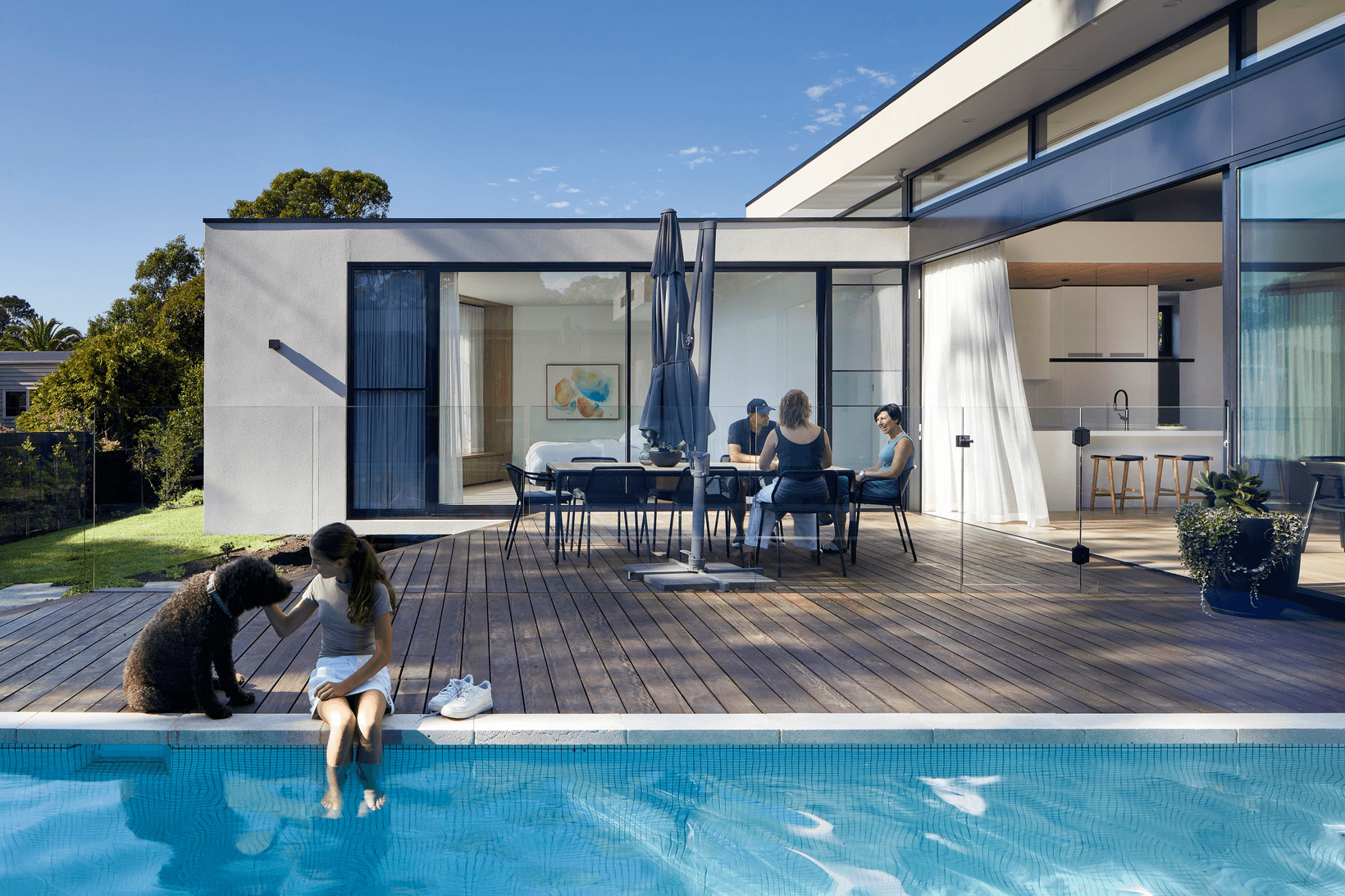 Sky Home Girl and dog next to pool